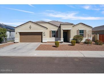 Single-story home with a two-car garage and landscaping at 269 S 190Th Dr, Buckeye, AZ 85326