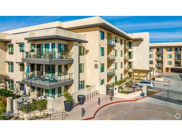 Modern apartment building with parking and landscaping at 7300 E Earll Dr # 1012, Scottsdale, AZ 85251