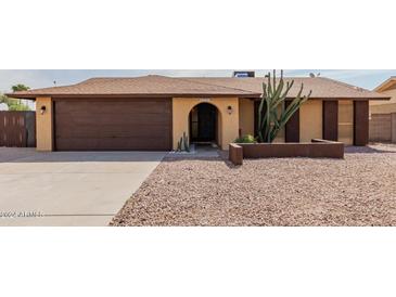 House exterior featuring a two-car garage and desert landscaping at 3837 W Dailey St, Phoenix, AZ 85053