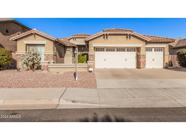 Beautiful home with a three-car garage and well-manicured landscaping at 1364 E Grand Canyon Dr, Chandler, AZ 85249