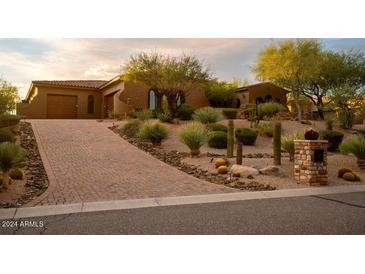 Brick driveway leading to a beautiful, single-story home with desert landscaping at 36482 N Boulder View Dr, Scottsdale, AZ 85262