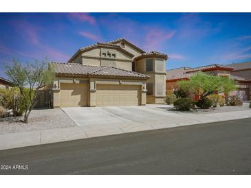Two-story house with three-car garage and desert landscaping at 18516 W Sweet Acacia Dr, Goodyear, AZ 85338