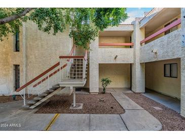 Exterior view of building with stairs and landscaping at 3119 W Cochise Dr # 245, Phoenix, AZ 85051