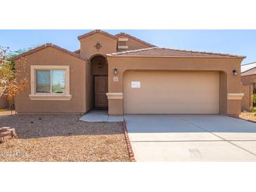 Tan one-story home with a two-car garage at 727 W Judi Dr, Casa Grande, AZ 85122