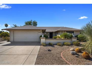 Single-story home with a two-car garage and nicely landscaped yard at 9856 W Rimrock Dr, Peoria, AZ 85382