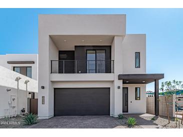 Modern two-story home with dark gray garage door at 10223 E Ulysses Ave, Mesa, AZ 85212