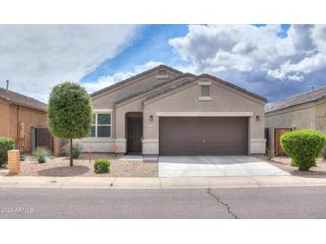 Charming one-story home with a brown garage door and well-manicured front yard at 17078 N Rosemont St, Maricopa, AZ 85138