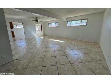 Spacious living room with tile floors and ceiling fan at 3023 W Larkspur Dr, Phoenix, AZ 85029