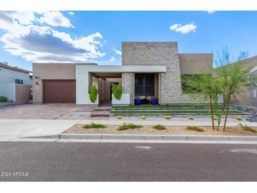 Modern home with stone accents and landscaped yard at 9626 S 7Th Pl, Phoenix, AZ 85042