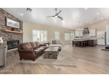 Open concept living room and kitchen with hardwood floors at 20362 E Bronco Dr, Queen Creek, AZ 85142