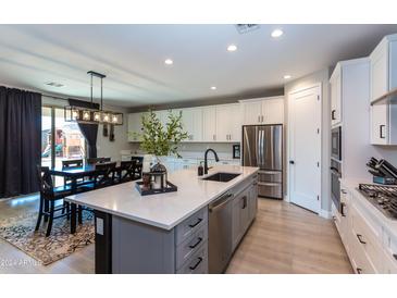 Modern kitchen with island, stainless steel appliances, and breakfast bar at 17663 W Straight Arrow Ln, Surprise, AZ 85387
