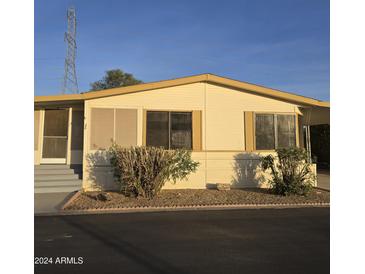 Charming single-story home with desert landscaping and covered entryway at 11596 W Sierra Dawn Blvd # 28, Surprise, AZ 85378