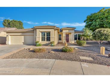One-story house with a two-car garage and desert landscaping at 42929 W Castle Cove Cir, Maricopa, AZ 85138