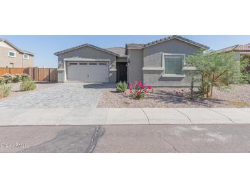 Single-story home with gray exterior and paver driveway at 22207 N Daniel Dr, Maricopa, AZ 85138