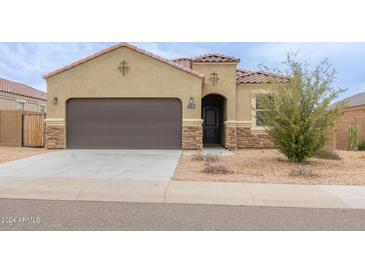 Single-story home with a two-car garage and desert landscaping at 1134 E Palm Parke Blvd, Casa Grande, AZ 85122