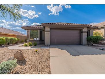 One story home with two car garage and desert landscaping at 42930 N Voyage Trl, Phoenix, AZ 85086