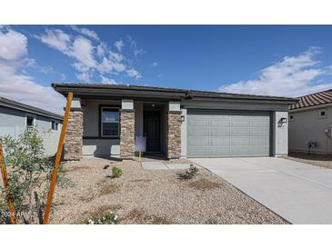 Newly constructed home with a gray exterior and 2 car garage at 40040 W Bravo Dr, Maricopa, AZ 85138