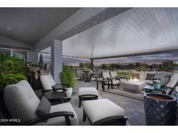 Relaxing covered patio with comfortable seating and fire pit at 331 W Dundy St, San Tan Valley, AZ 85143