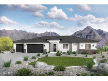 Modern single story house with a two car garage and desert landscaping at 18083 W Amber Dr, Goodyear, AZ 85338
