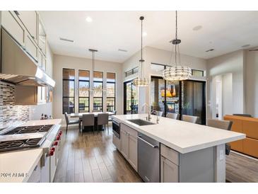 Gourmet kitchen with an island, breakfast nook and views of the backyard at 16076 E Ridgestone Dr, Fountain Hills, AZ 85268