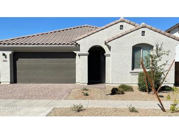 Modern stucco home with a two-car garage and desert landscaping at 14436 W Faye Way, Surprise, AZ 85387