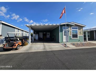 Attractive exterior of the home with a carport and golf cart at 650 N Hawes Rd # 3820, Mesa, AZ 85207