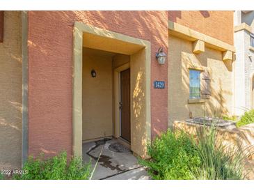 Condo entrance with a brown door and desert landscaping at 2402 E 5Th St # 1429, Tempe, AZ 85288