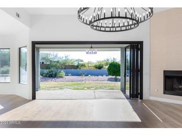 Bright living room with sliding doors opening to backyard at 6035 E Monterra Way, Scottsdale, AZ 85262