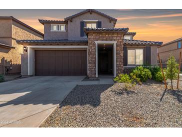 Two-story home with stone accents and a two-car garage at 23095 E Mewes Rd, Queen Creek, AZ 85142