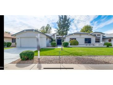 Single-story home with a well-maintained lawn and attractive landscaping at 13035 W Ballad W Dr, Sun City West, AZ 85375