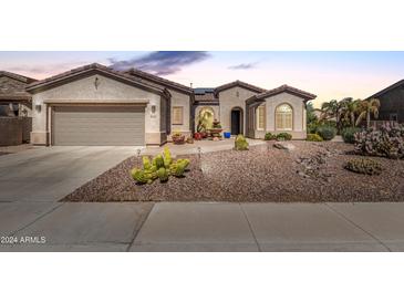 Single-story home with a two-car garage and desert landscaping at 4234 E Narrowleaf Dr, Gilbert, AZ 85298