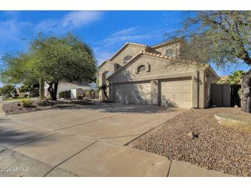 Two-story home with attached two-car garage and landscaped yard at 5542 E Anderson Dr, Scottsdale, AZ 85254