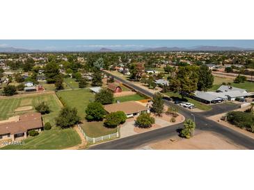 Aerial view of a property with a large yard and neighboring houses at 966 E Desert Ln, Gilbert, AZ 85234