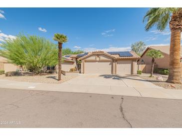 Single-story home with two-car garage and solar panels at 8737 W Kimberly Way, Peoria, AZ 85382