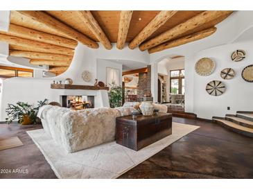 Spacious living room with wood-beamed ceiling and fireplace at 8300 E Dixileta Dr # 263, Scottsdale, AZ 85266