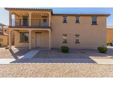 Two story home with balcony and desert landscaping at 913 E Agua Fria Ln, Avondale, AZ 85323