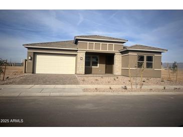 One-story home with light brown exterior, cream garage door, and small front yard landscaping at 790 W Superstition Dr Dr, Queen Creek, AZ 85140