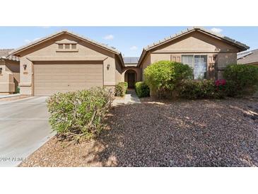 Two-car garage and well-maintained landscaping at 14588 W Laurel Ln, Surprise, AZ 85379