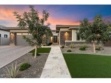 Modern home exterior with a landscaped yard and walkway at 9622 W Villa Chula Dr, Peoria, AZ 85383
