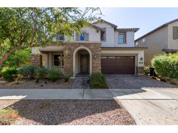 Two-story home with stone accents and a brown garage door at 10523 E Simone Ave, Mesa, AZ 85212