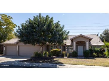Single story home with a two-car garage at 2057 E Marquette Dr, Gilbert, AZ 85234