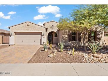 Two-story house with a three-car garage and desert landscaping at 11856 W Lone Tree Trl, Peoria, AZ 85383