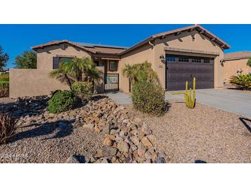 Single-story home with a two-car garage and desert landscaping at 744 E Laddoos Ave, Queen Creek, AZ 85140