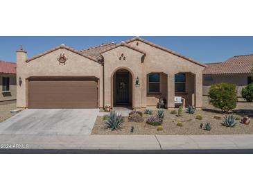 Tan two-car garage home with desert landscaping at 26404 W Zachary Dr, Buckeye, AZ 85396
