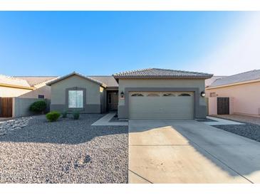 Single-story home with attached garage and desert landscaping at 13585 W Ironwood St, Surprise, AZ 85374