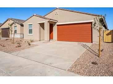 One-story home with orange garage door and landscaping at 17416 W Sanna St, Waddell, AZ 85355