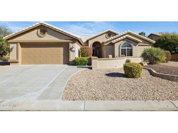 Single-story home with a two-car garage and landscaped yard at 15758 W Edgemont Ave, Goodyear, AZ 85395
