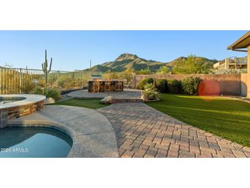 Landscaped backyard oasis with a pool, spa, and mountain views at 2554 N Tambor --, Mesa, AZ 85207