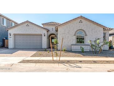 Modern two-car garage home with light-colored exterior and landscaping at 25952 S 224Th Pl, Queen Creek, AZ 85142