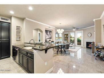 Open concept living area with kitchen island, fireplace, and dining area at 7601 E Indian Bend Rd # 1061, Scottsdale, AZ 85250